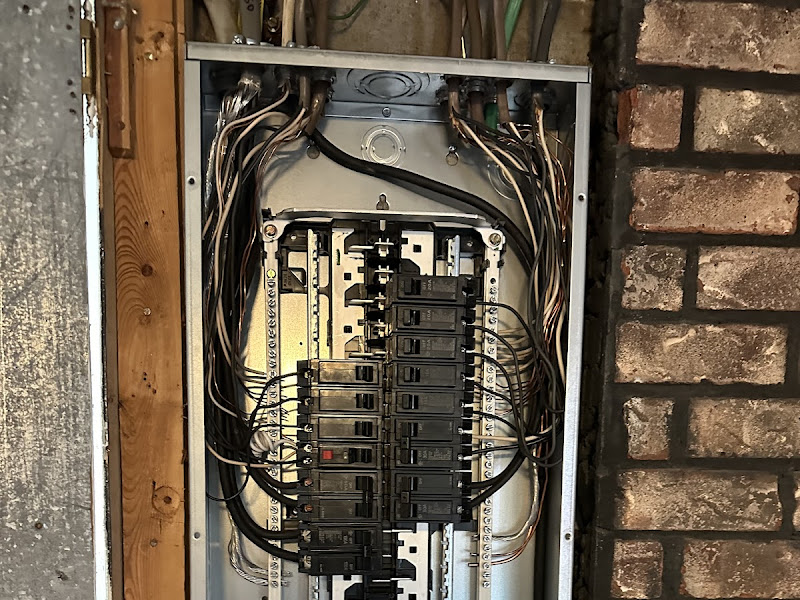 Open electrical panel with newly installed breakers, a real Electrical Innovations job